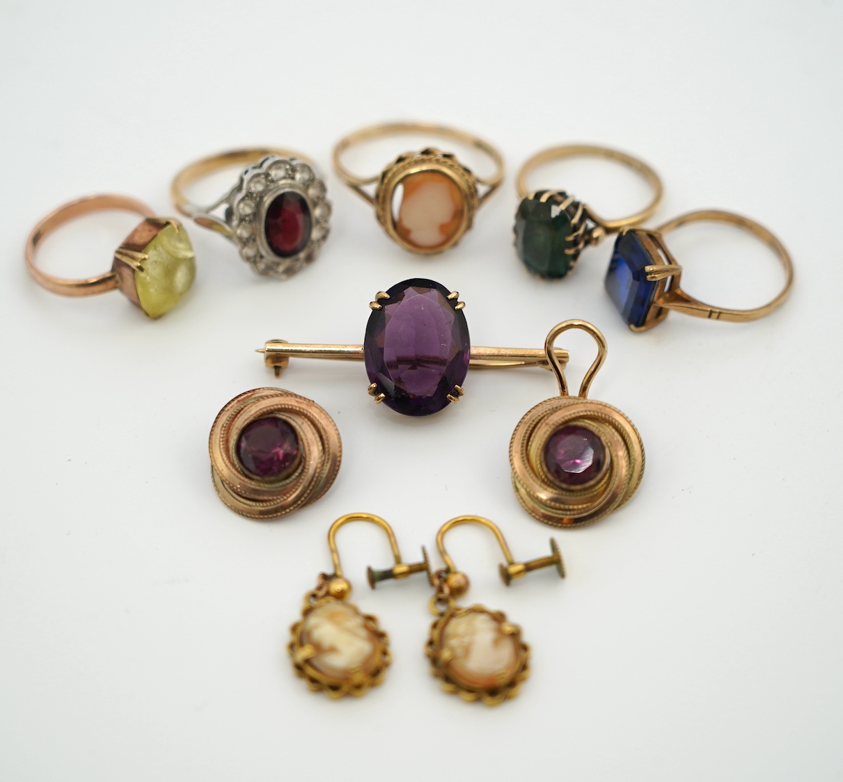 Five assorted 9ct and gem set rings, including cameo shell, two pairs of ear clips including 9ct cameo shall with rolled gold clip and a yellow metal and gem set bar brooch. Condition - poor
